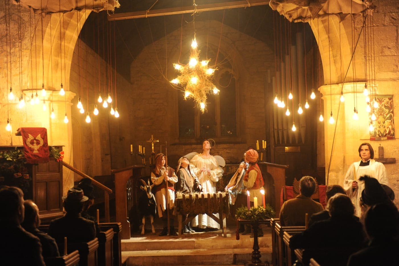 A candlelit church scene from The Christmas Candle